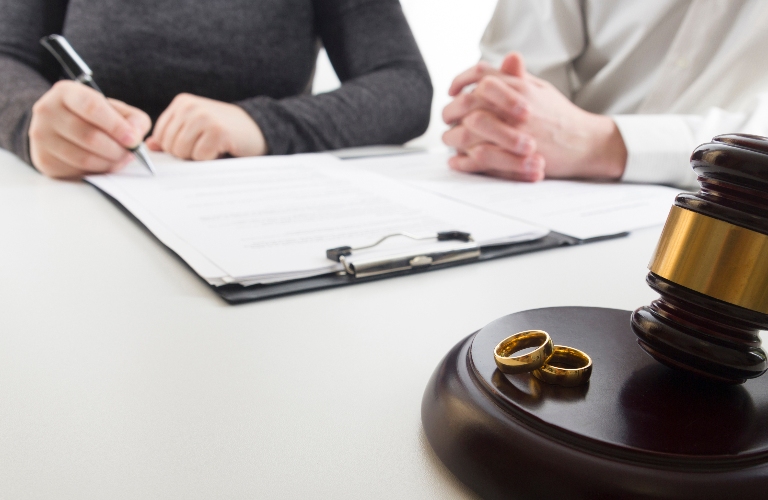 hands of wife husband signing decree of divorce s